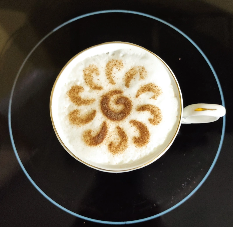 A stencilled cup of coffee using a laser cut mylar stencil